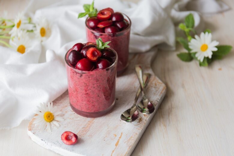 Two,Glasses,With,Cherry,Chia,Pudding,Decorated,With,Cherries,And