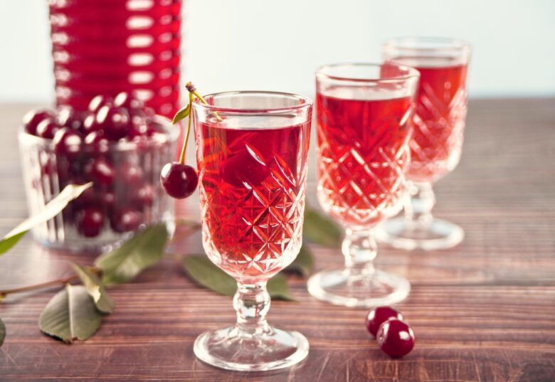 Glasses,Of,Cherry,Brandy,Liqueur,With,Ripe,Berries