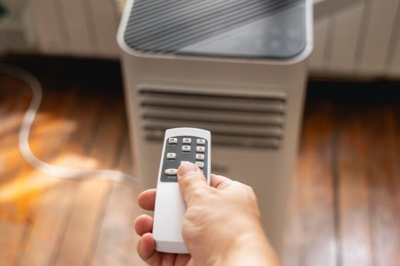 Close-up,Of,A,Hand,Pressing,The,Remote,Control,For,An