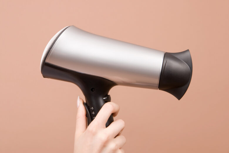 Hair,Drier,In,Hand,Isolated,On,Beige,Background