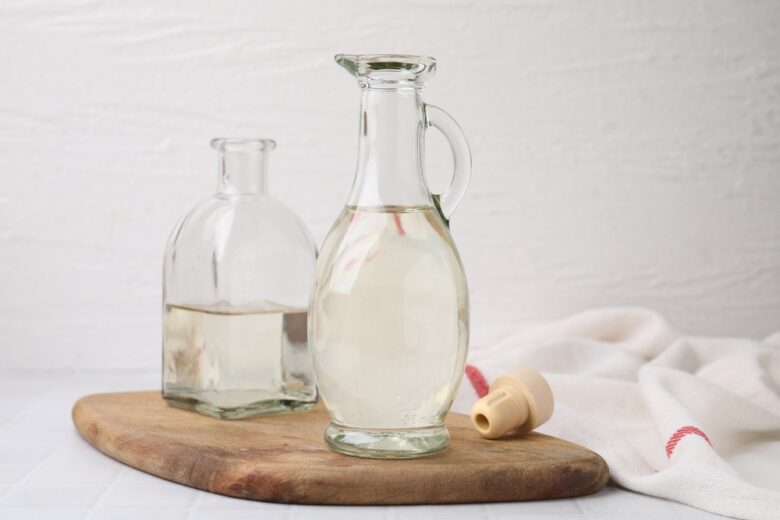 Vinegar,In,Glass,Jug,And,Bottle,On,White,Table