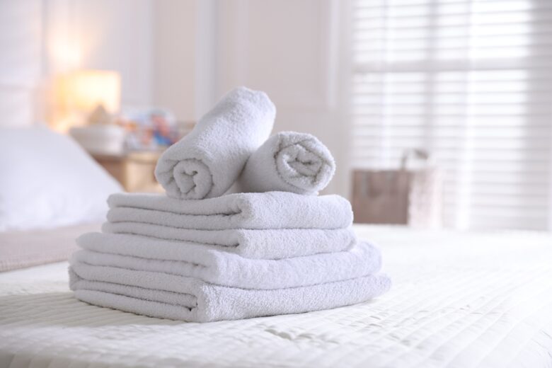Stack,Of,Clean,Towels,On,Bed,Linens,At,Home,,Closeup