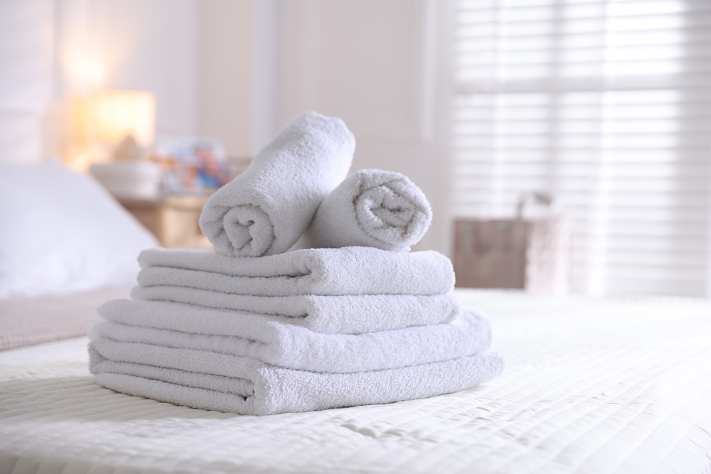 Stack,Of,Clean,Towels,On,Bed,Linens,At,Home,,Closeup Stack,Of,Clean,Towels,On,Bed,Linens,At,Home,,Closeup