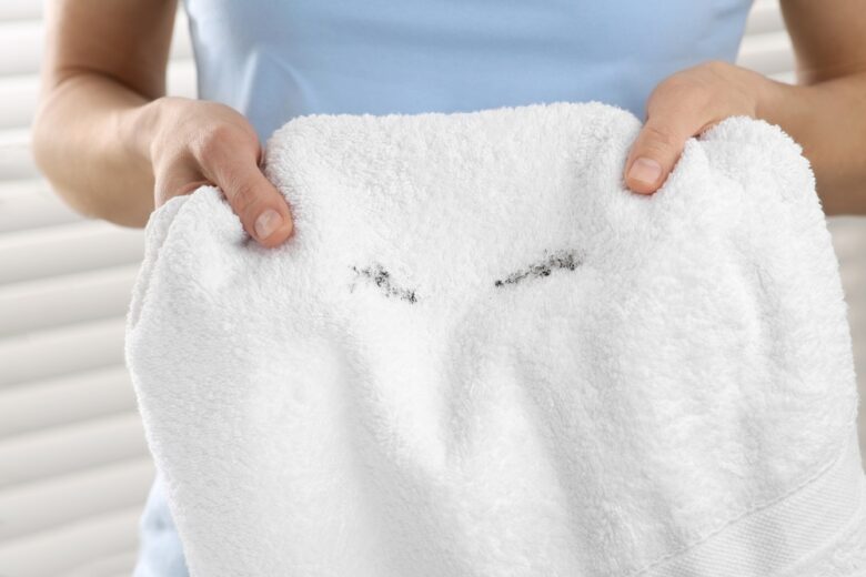 Woman,Holding,Terry,Towel,With,Mascara,Spot,Indoors,,Closeup.,Makeup