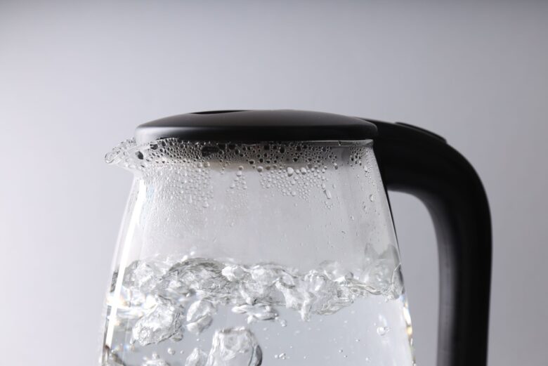 Water,Boiling,In,Electric,Kettle,On,Light,Grey,Background,,Closeup