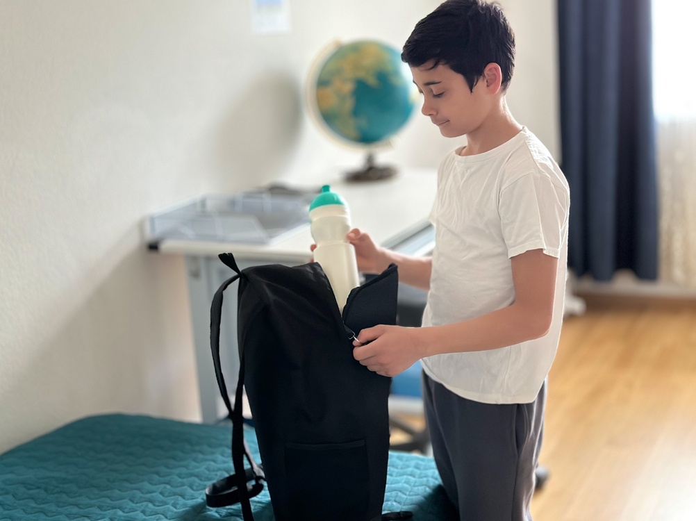 The,Boy,Is,Packing,His,Backpack,In,The,Children’s,Room. The,Boy,Is,Packing,His,Backpack,In,The,Children’s,Room.