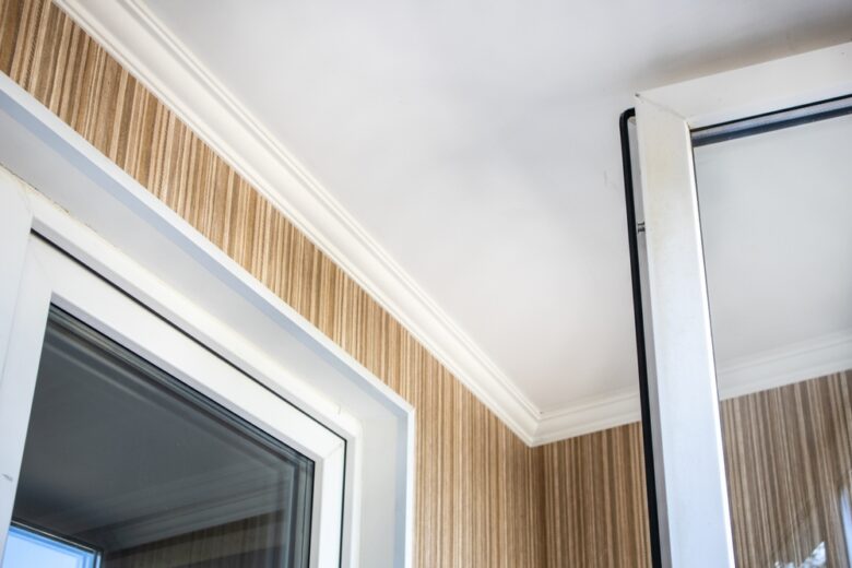 Interior,Corner,With,White,Ceiling,Molding,And,Pvc,Window,Against