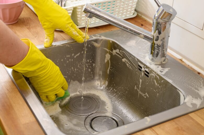 Scrubbing,Stone,From,The,Kitchen,Sink,,Chemical,Care,Products,For