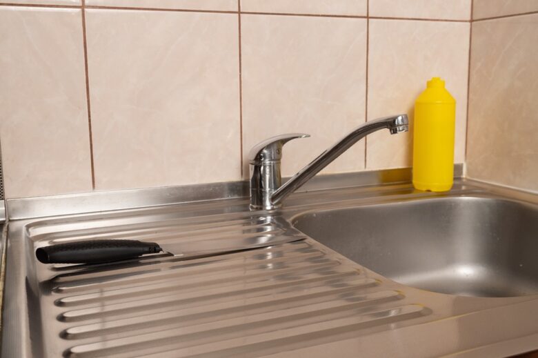 Kitchen,Sink,With,Metal,Faucet,,Kitchen,Knife,On,Surface,And