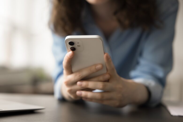 Close,Up,View,Of,Unrecognizable,Woman,Using,Smartphone,For,Browsing