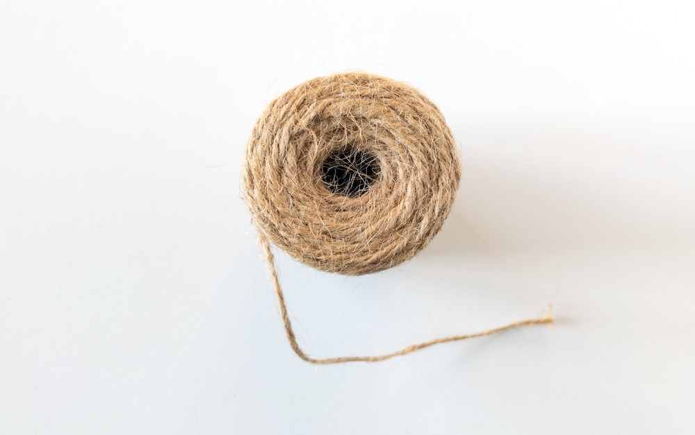 Jute,Twine,Whipping,Rope,On,A,White,Background,,Top,View. Jute,Twine,Whipping,Rope,On,A,White,Background,,Top,View.