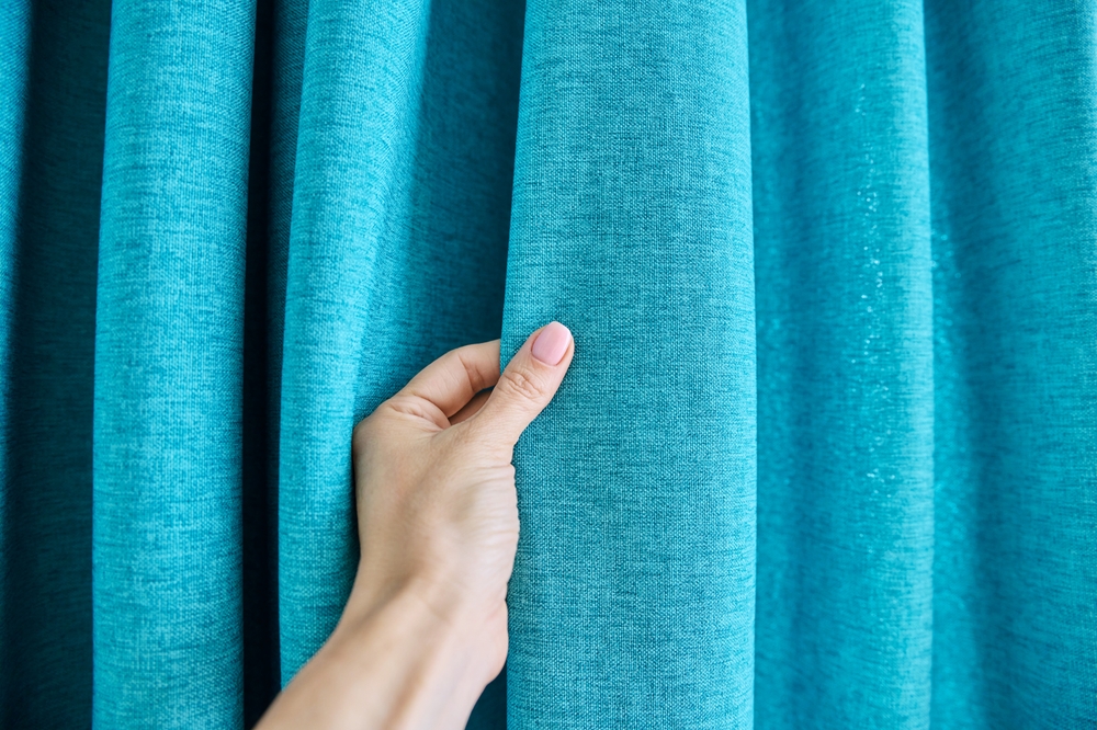 Blue,Turquoise,Textured,Polyester,Curtains,On,Window,,Close-up,Of,Hand Blue,Turquoise,Textured,Polyester,Curtains,On,Window,,Close-up,Of,Hand